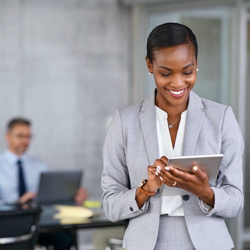 Black business woman using digital tablet in meeting room