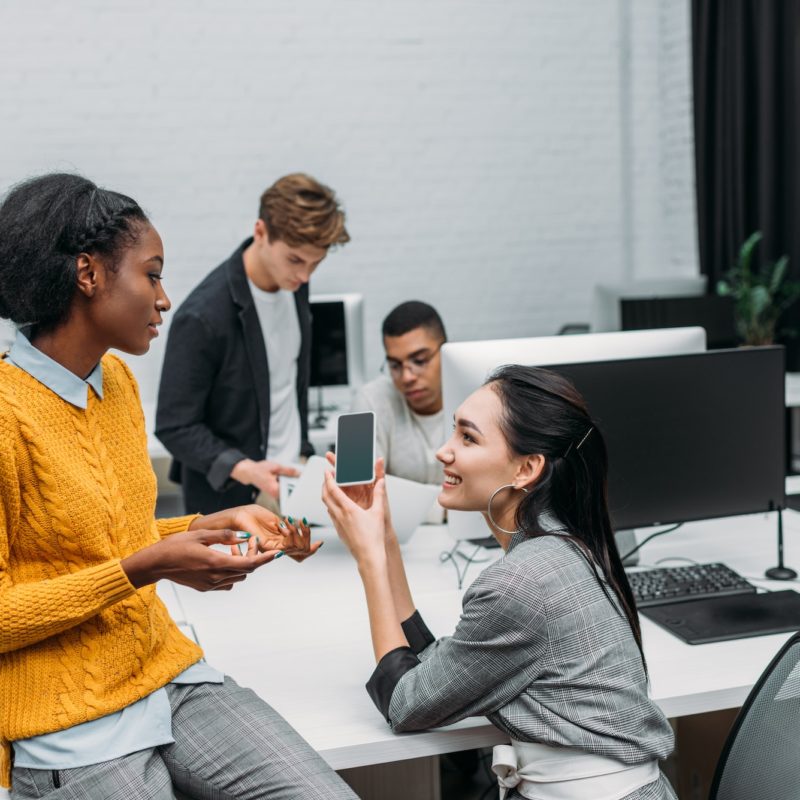 group of multiethnic business partners talking at office