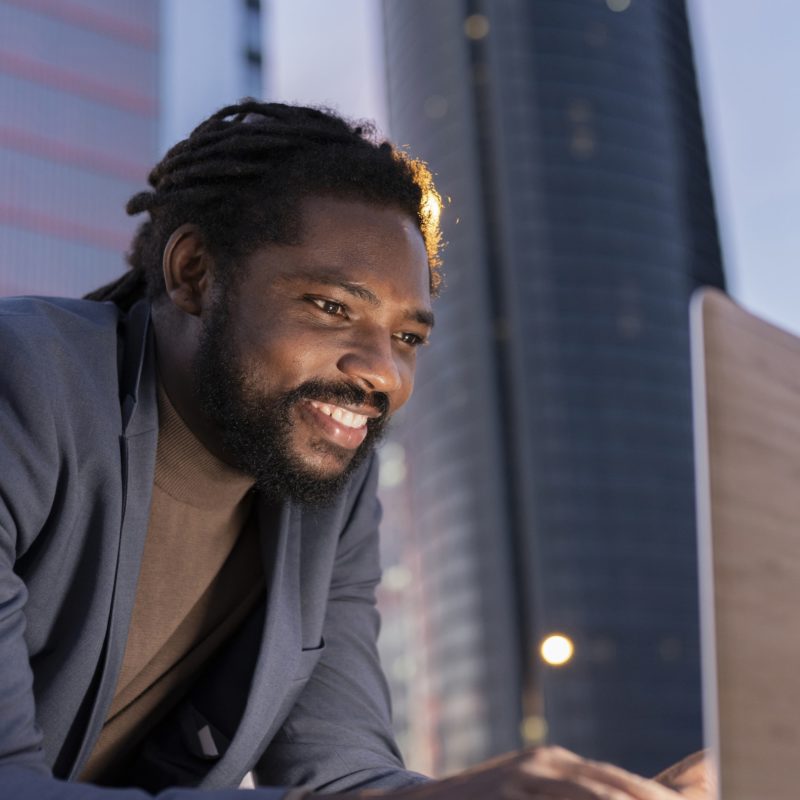 man in city with laptop business at night