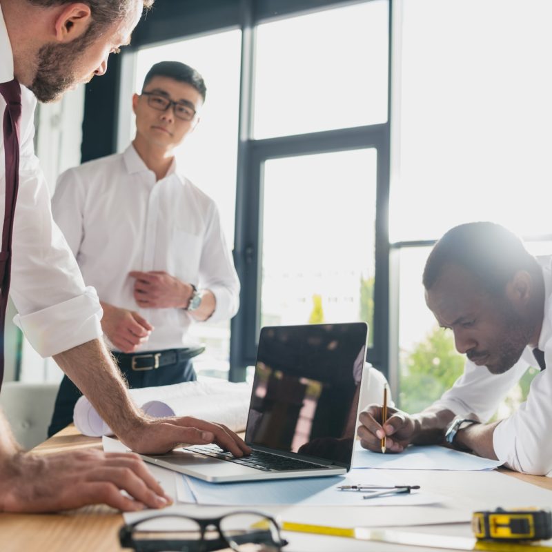 professional architects in formal wear working at modern office, businessmen group